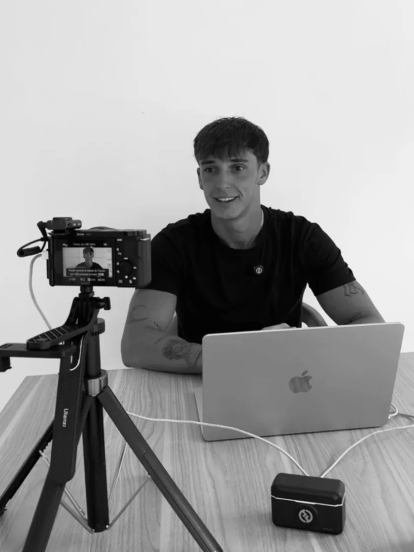 Christian, founder of 404 Growth, at his desk with a laptop and a camera